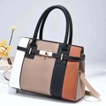Detail view of large color-block handbag with metallic gold twist lock and smooth texture - Khaki
