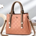 Pink checkered crossbody bag with laser-cut pattern and contrast brown handles - Pink