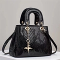 Elegant black snakeskin pattern handbag with gold star pendant and round handles - Black
