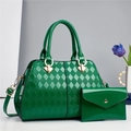Detail of emerald green patent leather tote with quilted pattern and gold hardware - Green
