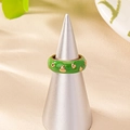 Green enamel ring featuring gold heart accents on a grey conical display stand - Green