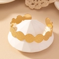 Elegante gouden open armband met gegolfde matte textuur en gepolijste binnenkant op sokkel - Goud