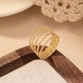 Chic multi-layer gold spiral ring with textured finish shown on a wooden tray - Gold