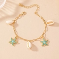 Detailed macro view of starfish shell bracelet with golden chain and blue enamel charms - Light Blue Starfish (5656511554574)