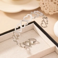 Elegant silver hollow heart open arm cuff bracelet displayed on a velvet jewelry box - Silver