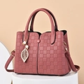Large rose pink tote bag with quilted texture, gold leaf pendant, and top handles - Pink