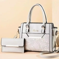 Detail of grey shoulder bag with white lace floral texture and gold hardware accents - Light Gray