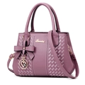 Elegant purple litchi grain handbag with bow and heart pendant on white background - Gray