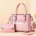 Detail of pink faux leather tote bag set with floral embossing and matching wallet - Pink