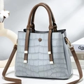 Detailed stone-patterned trapezoid handbag with gold hardware and brown handles - Mint Green