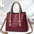 Elegant crocodile embossed burgundy tote bag with brown handles and gold hardware detailing - Red
