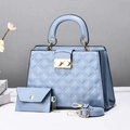 Detail view of light blue quilted tote bag set with golden hardware and accessories - Blue