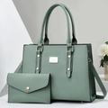 Detailed view of the sage green matte leather tote bag and matching envelope wallet set - Green
