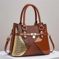 Detail of lizard pattern leather handbag with gold-tone hardware and secure twist-lock - Earthy Yellow