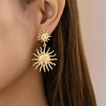 Bohemian gold sun face drop earrings featuring a vintage sunburst design on a model - Gold Yellow