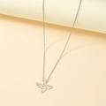 Minimalist silver bee pendant necklace with geometric hollow design on warm background - White Gold