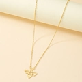 Detailed view of a gold bee pendant necklace with minimalist hollow design on warm background - Gold