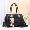 Black quilted faux leather tote bag with gold hardware and pink pompom keychain detail - Black