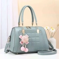 Detail of light blue quilted tote bag with lychee texture and pink ribbon charm - Light Blue