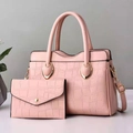 Pink stone pattern tote bag and matching clutch with gold metal handles in modern setup - Pink