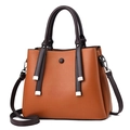 Orange and brown contrast tote bag with tassel charms and pebbled leather texture - Earthy Yellow