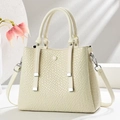 Close-up of cream woven texture tote bag with silver hardware on a minimalist background - White