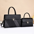 Black and charcoal grey two-piece striped handbag set with silver U-shaped metal clasp - Black