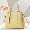 Light yellow checkered tote bag with top handles and adjustable shoulder strap on stand - Yellow