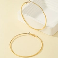 Grandi orecchini a cerchio dorati minimalisti con finitura lucida su sfondo geometrico - 7cm / Oro