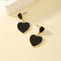 Detail of asymmetric double heart earrings in black enamel and gold finish on stone base - Enamel Black Heart Style