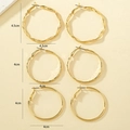 Three pairs of golden hoop earrings featuring twisted, wavy, and smooth metal textures - Gold Set (3 Pairs)