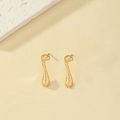 Macro detail of minimalist gold-plated musical note stud earrings with high-polish finish - Music Note Style