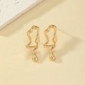Detail of minimalist fluid gold music note earrings with a liquid lava metallic finish - Ear Shaped Fluid Style