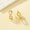 Elegant gold infinity symbol stud earrings on a textured beige background - Gold