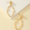 Polished gold alloy twisted drop earrings with minimalist oval pendants for women - Gold