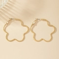 Textured gold flower hoop earrings with hammered finish and minimalist hollow heart design - Gold