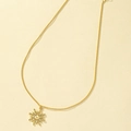 Elegant gold sun pendant necklace with minimalist wavy sunburst pattern on matte background - Gold