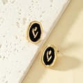 Enamel tulip earrings in irregular gold frames on a natural stone display - Gold
