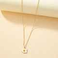 Chic gold necklace with a cute enamel fried egg pendant on a minimalist cream background - Gold