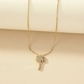 Luxurious gold palm tree necklace with sparkling rhinestones on a minimalist background - Gold