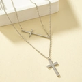 Macro view of double-layered silver cross necklace with pavé cubic zirconia accents - White Gold