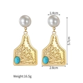 Detail view of 18k gold earrings with white pearl and turquoise showing 5.7cm dimensions - Irregular Plate Radiating Relief (Style D)