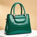 Glossy green crocodile pattern tote bag with gold hardware on marble base - Stone Grey