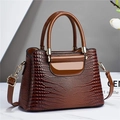 Detail of dark brown faux-crocodile texture on structured tote bag with gold hardware - Khaki/Earth Yellow