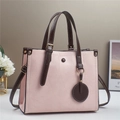 Pink patchwork faux leather shoulder bag with textured geometric pattern and brown handles - Pink