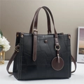 Elegant two-tone contrast leather tote bag with top handles and adjustable shoulder strap - Black