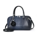 Navy blue faux crocodile texture handbag with black handles and a floral charm pendant - Blue