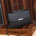 Minimalist black leather handbag with round metal handles and detachable shoulder strap - Black