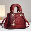 Dark red crocodile embossed handbag with gold star pendant and sturdy top handles - Red