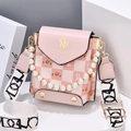 Pink checkered crossbody bag with pearl handle and wide fabric strap in studio setting - Pink
